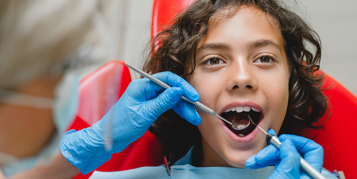 child patient recieving a teeth cleaning